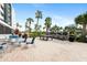 Community patio with tables, grills and palm trees at 5855 Midnight Pass Rd # 520, Sarasota, FL 34242