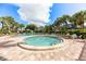 Community pool and spa with surrounding lounge chairs at 5855 Midnight Pass Rd # 520, Sarasota, FL 34242