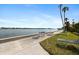 Scenic waterfront walkway with benches and lounge chairs at 5855 Midnight Pass Rd # 520, Sarasota, FL 34242