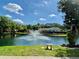 Serene pond view with a fountain and manicured landscaping at 625 30Th W Ave # G409, Bradenton, FL 34205