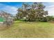 Spacious backyard with a large tree and seating area at 6307 30Th E Ave, Palmetto, FL 34221