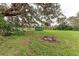 Large backyard with a shipping container and fire pit at 6307 30Th E Ave, Palmetto, FL 34221