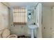 Small bathroom with pedestal sink, toilet, and shower. Needs renovation at 6307 30Th E Ave, Palmetto, FL 34221