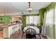 Bright dining area with kitchen pass-through and wood flooring at 6307 30Th E Ave, Palmetto, FL 34221