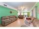 Bright living room featuring two leather sofas and a ceiling fan at 6307 30Th E Ave, Palmetto, FL 34221