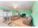 Living room with brown sofas, wood floors, and a ceiling fan at 6307 30Th E Ave, Palmetto, FL 34221