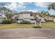 Front view of a two-story condo building with stairs and landscaping at 712 Bird Bay Dr # 146, Venice, FL 34285