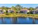 Home with a screened lanai overlooking a tranquil lake at 7220 Kensington Ct, University Park, FL 34201