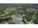 Aerial view of community landscape with tennis courts and lake at 7220 Kensington Ct, University Park, FL 34201