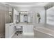 Elegant bathroom with soaking tub, shower, and vanity at 7220 Kensington Ct, University Park, FL 34201