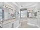 Elegant bathroom with double vanity and soaking tub at 7220 Kensington Ct, University Park, FL 34201