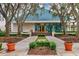 Clubhouse entrance with landscaping and walkway at 7220 Kensington Ct, University Park, FL 34201