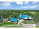 Clubhouse with teal roofs and patio seating at 7220 Kensington Ct, University Park, FL 34201