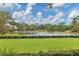 Scenic croquet lawn with pond and home views at 7220 Kensington Ct, University Park, FL 34201