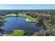 Aerial view of lush golf course and lake at 7220 Kensington Ct, University Park, FL 34201