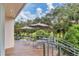 Private outdoor patio with tables, umbrellas, and golf course views at 7220 Kensington Ct, University Park, FL 34201