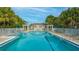 Community pool with lounge chairs and a spa at 7220 Kensington Ct, University Park, FL 34201