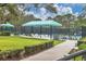 Tennis courts with shaded seating areas at 7220 Kensington Ct, University Park, FL 34201