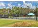 Community tennis courts nestled among lush greenery at 7220 Kensington Ct, University Park, FL 34201