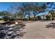 Paver driveway leads to a well maintained home with mature trees and manicured landscaping at 73 Tidy Island Blvd, Bradenton, FL 34210