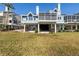 Back of home featuring large, covered patio space and upper level decks, perfect for outdoor entertaining at 73 Tidy Island Blvd, Bradenton, FL 34210