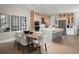 Kitchen and dining area with modern light fixtures and hardwood flooring at 7318 Marathon Dr, Seminole, FL 33777