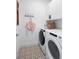 Convenient laundry room with washer, dryer, and patterned tile floor at 7334 Marathon Dr, Seminole, FL 33777