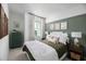 Cozy bedroom featuring a green accent wall and neutral bedding at 7350 Marathon Dr, Seminole, FL 33777