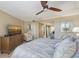 Spacious bedroom with a large bed, dresser, and ocean view at 775 Longboat Club Rd # 304, Longboat Key, FL 34228