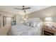 Main bedroom with plush bedding and ceiling fan at 775 Longboat Club Rd # 304, Longboat Key, FL 34228