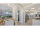 View of kitchen and dining area with access to balcony at 775 Longboat Club Rd # 304, Longboat Key, FL 34228