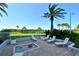 Relaxing patio with seating and fire pit, overlooking green space at 775 Longboat Club Rd # 304, Longboat Key, FL 34228