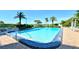 Inviting swimming pool with lounge chairs and lush landscaping at 775 Longboat Club Rd # 304, Longboat Key, FL 34228