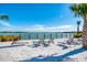 Lakefront sandy beach with lounge chairs for relaxing at 7872 Mainsail Ln, Sarasota, FL 34240