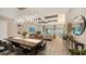 Elegant dining room with a long wooden table and modern light fixture at 7872 Mainsail Ln, Sarasota, FL 34240