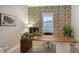 Home office with wood desk, geometric wallpaper, and plenty of natural light at 7872 Mainsail Ln, Sarasota, FL 34240