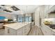 Gourmet kitchen boasts white cabinets, quartz countertops, and high-end appliances at 7872 Mainsail Ln, Sarasota, FL 34240