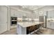 Bright kitchen with white cabinets, quartz countertops, and breakfast bar at 7872 Mainsail Ln, Sarasota, FL 34240