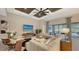 Living room with sectional sofa, coffered ceiling, and pool view at 7872 Mainsail Ln, Sarasota, FL 34240