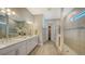 Elegant main bathroom with dual vanities, a large shower, and modern finishes at 7872 Mainsail Ln, Sarasota, FL 34240