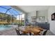 Covered patio features a pool, outdoor kitchen, and seating area at 7872 Mainsail Ln, Sarasota, FL 34240