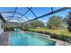 Inviting swimming pool with a water feature and screened enclosure at 7872 Mainsail Ln, Sarasota, FL 34240