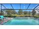 Refreshing swimming pool with screened enclosure and tranquil backyard view at 7872 Mainsail Ln, Sarasota, FL 34240