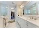 Double vanity bathroom with a large mirror and walk-in shower at 8112 Slipway Dr, Sarasota, FL 34240