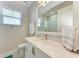 Clean bathroom with white vanity, quartz countertop, and a walk-in shower at 8112 Slipway Dr, Sarasota, FL 34240