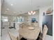 Bright dining room with wood table and chairs, open to kitchen and living room at 8112 Slipway Dr, Sarasota, FL 34240