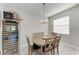 Casual dining area with wood table and chairs, near kitchen and wine fridge at 8112 Slipway Dr, Sarasota, FL 34240