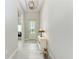 Bright and airy entryway with tile floors and a white console table at 8112 Slipway Dr, Sarasota, FL 34240