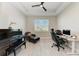 Bright home office with a piano, desk, and comfortable seating at 8112 Slipway Dr, Sarasota, FL 34240