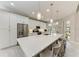 Modern kitchen with white cabinets, large island, and stainless steel appliances at 8112 Slipway Dr, Sarasota, FL 34240